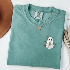 If you love Halloween & nostalgia - you NEED this Embroidered Ghost with Coffee Comfort Colors T-Shirt! This is perfect for the fall season- would also make a great gift for someone that is obsessed with all things Halloween/Fall. * PRODUCT DETAILS * ✺ 100% Cotton ✺ Wash and dry normally (on cool for best results) ✺ Due to different monitor screens, colors may vary ✺ * SIZING * ✺ FOR AN OVERSIZED FIT, SELECT TWO OR THREE SIZES UP FROM YOUR NORMAL SIZE ✺ ✺ Sizing is unisex ✺ Size guide: Please co Halloween Embroidered Crew Neck T-shirt, Halloween Cotton Top With Embroidered Graphics, Halloween Embroidered Cotton Tops, Halloween Cotton Embroidered Tops, Custom Embroidery Short Sleeve T-shirt, Embroidered Cotton Tops For Halloween, Casual Embroidered Halloween T-shirt, Ghost With Coffee, Halloween Nostalgia