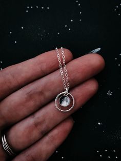 "This delicate pendant is positively darling. This petite necklace is available in sterling silver or 14k gold and is personalized with the moon phase that had been in the sky during an important occasion in your life! Was it the day you were born? Married? Had children? A life-changing experience? Whatever the moment, there was a phase of our moon shining down on it. This itty bitty moon hangs in the middle of a delicate gold or silver halo. To order, please provide the following information in Engraved Moonstone Round Jewelry, Round Engraved Moonstone Jewelry, Engraved Round Moonstone Jewelry, Dainty Silver Moon Shaped Jewelry, White Sun And Moon Round Pendant Jewelry, White Sun And Moon Design Round Pendant Jewelry, Celestial Silver Jewelry For Gifts, Sterling Silver Moon Engraved Necklace, Sterling Silver Moon Shaped Engraved Necklace