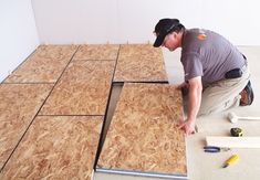 a man is working on some plywood flooring