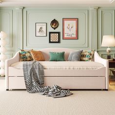 a living room filled with furniture and pictures on the wall above it's headboard