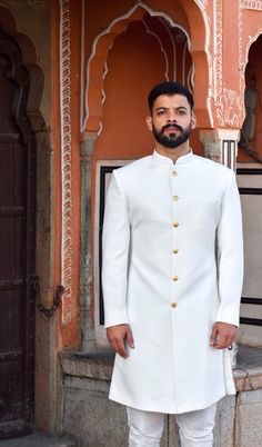 The stylish designer sherwani for men features a white cotton silk top and a white cotton churidar-style bottom, both of which are free size.  Size can be sent in cms also, For your comfort we keep a 2-inch margin so please provide the exact size without any margin The package includes: sherwani and churidar pajama.  Accessories such as mojris(shoes), stoles, turbans, and others are not included but can be ordered as extra as per your choice. White Sherwani For Men Wedding, Designer Sherwani For Men, Churidar Pajama, White Sherwani, Jodhpuri Suits For Men, Mens Wedding Suits, Cotton Churidar, Sherwani For Men Wedding, Sherwani For Men