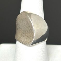 This stunning circa 1950s sterling silver ring beautifully embodies the Mid-Century-Modernist jewelry movement, as it has the depth, texture, weight, and edgy design that the era was renowned for. The ring is in wonderful condition, is Hallmarked "CS" or maybe "LS" by the maker, and is marked STERLING inside the shank. It is a size 8.75US,  weighs 13.1gr, and has a top width of almost 1". This ring would be suitable for men and women alike, and would make a fabulous addition to any MCM jewelry c Modernist White Gold Signet Ring In Sterling Silver, Modernist White Gold Sterling Silver Signet Ring, Modernist Oval Sterling Silver Ring, Modernist White Gold Signet Ring For Anniversary, Modernist Sterling Silver Signet Ring With Polished Finish, Modernist Sterling Silver Rings For Formal Occasions, Unique White Gold Signet Ring For Formal Occasions, Mid-century Polished Formal Jewelry, Modern Untreated Jewelry For Anniversary