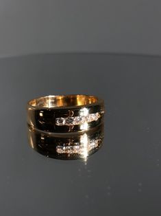 This Men's band is a classic diamond wedding band for the man who loves a little bling. It has a simple minimalist look with the channel style of setting the diamonds. Details: Size: The ring is a Size 12.5( can be sized upon request) The center stone is: Diamond Approximately .40ct G color/ SI1 clarity. Gram weight is: 9.5 grams Metal: 14K yellow Gold. The thickness at the top is 7.35mm and it tapers down at the bottom to 4.18 mm Every Antique piece of jewelry we sell at Heirloom Pavé has been Classic Wedding Band With Diamond Cut, Classic Diamond Cut Wedding Band, Formal Diamond Ring With Thick Band, Classic Wedding Band For Anniversary, Classic Marriage Rings With Band Shape, Anniversary Wedding Ring With Thick Diamond Cut Band, Classic Thick Band Diamond Promise Ring, Classic Thick Band Diamond Ring For Formal Occasions, Formal Thick Band Jewelry With Brilliant Cut