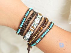 a close up of a person's arm wearing bracelets with beads on it