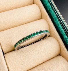 Natural french cut emerald eternity band in platinum. An original and hard to find piece from the Art Deco era. Not a reproduction!  Bright green emeralds encircle the entire ring. They are securely channel set with milgrain borders and beautifully carved details on the profile.  A small section of the profile has been left blank for engraving initials and/or a date. Ring size: 6 Metal: Platinum, unmarked, fully acid tested Gemstones: Natural emeralds Weight: 1.3 grams Measurements: 1.7mm wide w Emerald Eternity Band With Prong Setting For Formal Occasions, Formal Emerald Eternity Band With Prong Setting, Classic Green Eternity Band For Anniversary, Green Emerald Eternity Band With Emerald Cut, Emerald Channel Set Jewelry With Emerald Cut, Green Round Cut Eternity Band For Formal Occasions, Channel Set Emerald Ring, Fine Jewelry Emerald Channel Set, Formal Emerald Eternity Band