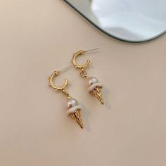 Description:Ice Cream Pearl Earrings Specifications:Size: 3.8 cm * 1.2 cmWeight: 6 g/pairMaterial: Alloy, Bronze, Artificial PearlColor: Gold/Silver Indulge your sweet side with these whimsical Ice Cream Pearl Earrings. Featuring playful ice cream cone designs with lustrous pearl accents, these earrings are the perfect addition to your fun and quirky style. Treat yourself or someone special to these delightful and unique earrings! 🍦💎 Cone Designs, Ice Cream Earrings, Handmade Ice Cream, Cream Earrings, Sweet Earrings, Daily Jewelry, Gold Pearl Earrings, Pearl Cream, Enamel Bracelet