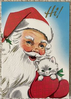 an old fashioned christmas card with santa holding a kitten