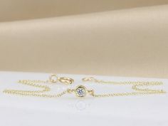 "Handmade by an inspired jewelry artist team with decades of experience in the craft of jewelry making. Each gemstone, each diamond is carefully picked. Using only the finest raw materials and the highest industry standard in manufacturing, design and finish. A beautiful dainty Diamond bracelet just for you. 14K yellow gold bracelet set with a single 2.5 mm Diamonds VS-E 0.5 ct √ Made in Solid 14K Gold, in your choice of color: Rose Gold, Yellow Gold, White Gold with Rhodium plating (see selecti Minimalist Bezel Set Bracelet For Anniversary, Minimalist Bracelet With Bezel Setting For Anniversary, Minimalist Diamond Chain Bracelet With Single Diamond, Minimalist Gold Bracelet With Diamond Cut For Anniversary, Minimalist Diamond Cut Bracelet In Diamond White, Minimalist Diamond White Bracelet With Diamond Cut, Minimalist White Gold Bracelet With Single Cut Diamonds, Dainty Diamond Bracelets With Bezel Setting, Minimalist Yellow Gold Diamond Bracelet With Adjustable Chain