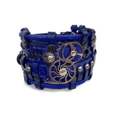 This blue leather bracelet looks absolutely stunning. It is designed for men and women who love steampunk or cyberpunk fashion trends.  It was made of genuine leather and decorated with metal parts Bracelet's width is about 2 in (5 cm) Bracelet's length is about 7.9 in (20 cm) It fits the wrist 7.1-8.3 in (19-22 cm) Please measure your wrist to make the correct choice  IMPORTANT - since it's a handmade item there might be slight variations in the design, however, the general idea and impression will be preserved. CARE No special care is required. Avoid chemical exposure including perfumery. If you need a custom order please let me know and I will try to do my best to prepare it for you:) If you have any questions feel free to ask.  Thank you for choosing shop Steampunk Adjustable Bracelets For Festivals, Adjustable Steampunk Festival Bracelets, Adjustable Steampunk Bracelets For Festivals, Adjustable Steampunk Leather Bracelet, Steampunk Leather Bracelet As A Gift, Steampunk Leather Bracelet Perfect As A Gift, Adjustable Blue Leather Cuff Bracelet, Blue Leather Jewelry For Festivals, Handmade Leather Punk Bracelet