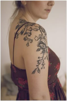 a woman with tattoos on her arm and shoulder