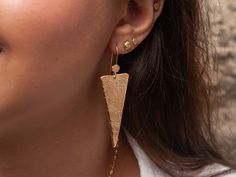 Hammered triangle drop earrings in bohemian style. Lightweight and perfect for everyday wear.  A unique and original form to bring personality and a little sparkle to your ears!  Perfect as a gift for yourself or for a loved one!  Specifications: ◈ Each triangle is 2-18mm (0.07-0.70inches) in diameter ◈ Each earring measures 18mm (0.70 inches) wide by 46mm (1.81 inches) long.  ◈ Weight: about 4g  ◈ Material: Solid 14k gold  ◈ Nickel free. ◈ All earrings with French ear wires come with silicon backings for extra protection. In case of custom orders - please contact us for pricing. ◈ SHIPPING is insured express and free worldwide ◈ GIFT WRAPPING is included with every purchase ✧ Looking for more unique and beautiful wedding bands: https://etsy.me/32OIpT5  ✧ Back to my shop for more handcraft Bohemian Triangle Earrings With Ear Wire, Bohemian Triangle Adjustable Earrings, Handmade Bohemian Geometric Earrings, Bohemian Gold Triangle Jewelry, Adjustable Gold Triangle Earrings, Bohemian Triangle Nickel-free Earrings, Gold Triangle Metal Earrings, Beautiful Wedding Bands, Boho Chic Earrings