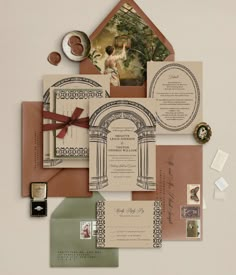 the wedding stationery is laid out on top of each other