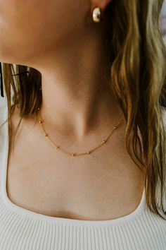 Our Dainty Gold Ball Chain Necklace is the perfect layering piece for your jewelry collection! Made with 24K Gold Filled metal, this necklace will not tarnish and is water prooff. Length: 18 InchesWidth : 1.3MM, BEAD-3.0MMIt has a spring clasp closure. Gold Satellite Chain Necklace As Gift, Station Necklace With Satellite Chain For Gift, Gold Station Necklace With Adjustable Chain For Gift, Satellite Chain Choker Jewelry Gift, Satellite Chain Choker As Gift, Gold-plated Satellite Chain Necklace, Hypoallergenic Link Necklace For Gift, Satellite Chain Charm Choker Necklace, Satellite Chain Charm Choker Necklaces As Gifts