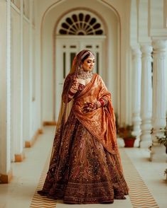 a woman in an orange and gold bridal gown