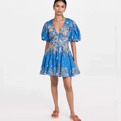 Look effortlessly chic in the Amyra Skater Short Dress. This dress is made from a cotton-linen blend and features a balloon sleeve and a plunge neckline for a timeless summer look. With this dress, you’ll be sure to stay comfortable and stylish all season long. Elegant V-neck Puff Sleeve Beach Dress, Blue V-neck Puff Sleeve Dress For Spring, Cotton V-neck Dress For Brunch, Summer V-neck Dress With Gathered Sleeves, V-neck Linen Dress With Floral Print, Linen V-neck Mini Dress For Vacation, Summer Dresses With Gathered Lantern Sleeves, Fitted Beach Dress With Lantern Sleeves, Spring Cotton Puff Sleeve Dress With Lantern Sleeves