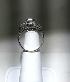 A wonderful Victorian band with great filigree detail. The center stone measures out at .80 ct and has a clarity of SI1 and G color. There is a small natural crystal on the girdle. On either side are 2 @.05ct diamonds set in diamond shape gold. The band weighs 2.5 grams and is is excellent condition. It measures 8.5mm across the top. Intricate White Gold And Platinum Jewelry, Platinum White Gold Jewelry With Intricate Design, Platinum Jewelry In White Gold With Intricate Design, Classic Brilliant Cut Diamond Jewelry, Formal 14k White Gold Filigree Ring, Anniversary Jewelry With Asscher Brilliant Cut, Fine Jewelry Platinum Filigree, Brilliant Asscher Cut Jewelry For Anniversary, Formal Jewelry With Vvs Clarity Round Cut