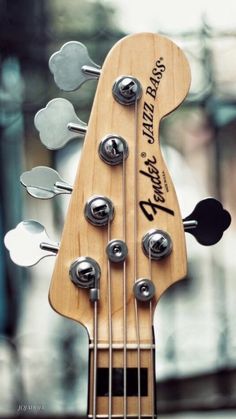 an electric bass guitar with metal knobs on it