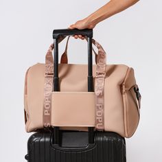 Introducing our Weekender bag, your ideal companion for stress-free packing on any getaway. Crafted with a water-resistant, 100% neoprene, this lightweight bag features an easy-access opening zipper and two side pockets for shoes or other essentials. The signature carry on sleeve effortlessly slides onto any suitcase, while a removable pouch, mesh pocket, and multiple interior pockets ensure optimal organization. Bonus points: the back zipper pocket is perfect for extra storage and the 19-inch s Sporty Rectangular Travel Accessories With Zipper Closure, Sporty Rectangular Travel Accessories With Zipper, Sporty Nylon Duffle Bag For Weekend Trips, Sporty Travel Accessories With Zipper For Daily Use, Sporty Zipper Closure Luggage For On-the-go, Sporty Luggage With Zipper Closure For On-the-go, Sporty Nylon Bag For Weekend Trips, Trendy Nylon Travel Bag For On-the-go, Sporty Tote Luggage With Sleeve