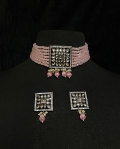 Women's Silver Plated pendant jewelry - Pink Bridal Choker Set & Earrings of CZ crystals A silver-plated choker with pink onyx drops adorns this bridal choker necklace. Contemporary ladies' bridal set with multilayered bead strands choker and Kundan gemstone earrings. This bridal choker jewelry set is accented with pink onyx & Kundan pendant making it one of a kind. The pendant of a square-shaped design is studded with CZ crystals & Pink Onyx. This contemporary choker is sure to make you feel li Silver Necklace With Sparkling Stones For Reception, Silver Jewelry With Sparkling Stones For Reception, Silver Choker Jewelry With Stones, Silver Choker With Stones, Silver Stone Choker Jewelry, Silver Bridal Necklace With Stone Setting For Celebrations, Dazzling Silver Kundan Necklace With American Diamond, Silver Kundan Necklace With Cubic Zirconia For Celebration, Dazzling Silver Bridal Necklace With Stone Setting