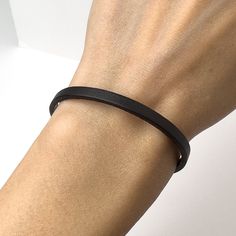 Leather Bracelet - Genuine Leather - Black Leather  - Black Bracelet - Stackable Bracelet - Leather Jewelry - Simple Leather Bracelet  Material: Genuine leather ( 4mm flat, black) and stainless steel clasp and elements. Free gift box: You will receive this bracelet in a beautiful gift box with cushion inside! Let me pleasantly surprise your loved ones on your behalf if it's a gift! If you need a special handmade jewelry - something unique or just have a question/comment just contact me via Etsy message. Love, Maria Classic Black Bracelets With Wrist Strap, Classic Black Bracelet With Wrist Strap, Adjustable Modern Black Wristband, Modern Adjustable Black Wristband, Black Bracelet For Everyday Use, Black Bracelets With Strap For Everyday Use, Everyday Black Bracelets With Wrist Strap, Adjustable Black Band Bracelet, Black Leather Strap Bracelets For Everyday Use