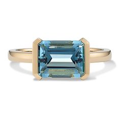 Simply stunning  this dreamy 14-karat yellow gold ring shines the spotlight on a single  natural aquamarine gemstone. It features an emerald cut positioned in a unique east-west (horizontal) orientation in a bezel setting. East West Sapphire Engagement Ring, Unique Gemstone Ring, Modern Blue Baguette Cut Emerald Ring, Modern 14k Gold Emerald Cut Topaz Ring, Timeless Emerald Cut Yellow Gold Topaz Ring, Timeless Emerald-cut Topaz Ring In Yellow Gold, Modern Yellow Gold Topaz Ring With Rectangular Shape, Modern Rectangular Blue Topaz Ring, 14k Gold Emerald Cut Topaz Ring