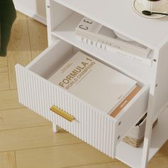 a white book shelf with books on it