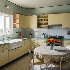 a kitchen filled with lots of counter top space next to a dining room table and chairs