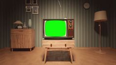 an old fashioned television with a green screen in a living room, next to two lamps