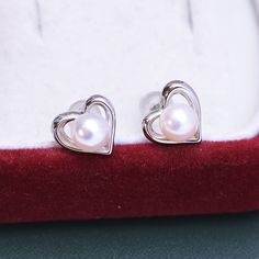 6-7mm Freshwater Pearl Heart Ear Stud Earrings #pearls #pearlsdaily #modernjewelry #pearlstrand #culturedpearls #motherofpearls #freshwaterpearls #luxuryjewelry #pearlstrands #modernpearls Silver Heart-shaped Pearl Jewelry, Silver Heart-shaped Pearl Drop Jewelry, Silver Double Heart Earrings For Formal Occasions, Silver Pearl Heart-shaped Earrings, Silver Heart-shaped Pearl Earrings, White Heart-shaped Pearl Earrings For Valentine's Day, Classic Silver Double Heart Earrings, Elegant Silver Heart Earrings For Formal Occasions, Valentine's Day White Pearl Earrings