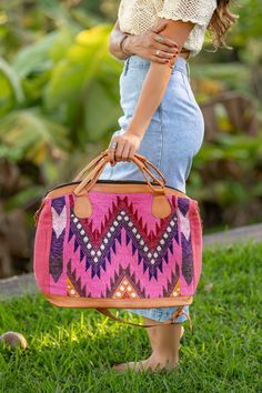 Big pink and black Mexican textile western leather boho duffle bag. This ethnic bohemian bag is the perfect large size bag. Great as a travel size carry on or overnight duffle bag,  One-of-a-kind and handmade in Mexico. This large statement bag is handmade with traditional Mexican textile. Made with 100% cotton combined with a light tan color 100% genuine leather.  This bag measures approximately 22 inches wide by 14.5 inches deep. The base of the bag measures approximately 7.5 inches wide by 17 Bohemian Satchel Duffle Bag For Trips, Bohemian Rectangular Bag With Luggage Sleeve, Bohemian Rectangular Duffle Bag With Leather Handles, Bohemian Duffle Bag With Leather Handles For Daily Use, Bohemian Brown Satchel Travel Bag, Bohemian Pink Bag With Double Handle, Bohemian Duffle Bag With Large Capacity For Trips, Bohemian Brown Duffle Bag With Leather Handles, Bohemian Brown Bags For Weekend Trips