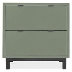 a green cabinet with two drawers sitting on top of it's legs and one drawer open