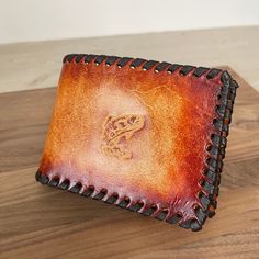 Custom Personalized Leather Wallet * Tooled BiFold Wallet *Western Cowboy Wallet Wallet Details: This Men's BiFold Leather Wallet is handcrafted with full grain leather, hand laced edges with calfskin lace using a single loop stitch. It features a hand stamped design of your choice. Hand dyed in a rich brown color and a top coat to protect your wallet for years of wear! Dimensions: LxH4 3/4 X 3 2/4 inches Spaces: 6 card slots and 1 bill compartment How to order: 1. Choose your stamp from picture Leather Bifold Coin Purse As Gift, Brown Bifold Coin Purse For Personal Use, Leather Rectangular Trifold Wallet For Personal Use, Handmade Bifold Coin Purse For Daily Use, Hand-stitched Bifold Wallet As Gift, Handmade Bifold Wallets For Everyday Use, Handmade Bifold Card Holder For Daily Use, Custom Rectangular Trifold Wallet With Coin Pocket, Hand-stitched Bifold Wallets For Gifting