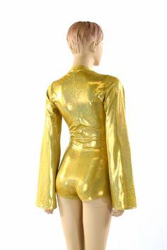 "This item is made to order, please read all the way through the listing before purchasing! This bodysuit is made of a gold metallic holographic sparkly jewel spandex. Long Bell cut sleeves and boy cut legs. This fabric has an amazing holographic sparkle! Deep, plunging v neckline. Four way stretch for a figure forming fit. This bodysuit is unlined. Womens Sizing (See below for instructions on where measurements should be taken) XXS: Bust 29\"-30\" / Waist 22\"-23\" / Hips 30\"-32\" Extra Small: Metallic Stretch Bodysuit For Club, Metallic Shiny Fitted Bodysuit, Fitted Metallic Shiny Bodysuit, Party Shimmer Stretch Bodysuit, Gold Long Sleeve Bodysuit For Night Out, Party Bodysuit With Shimmer And Stretch, Metallic Fitted Long Sleeve Bodysuit, Shimmer Stretch Bodysuit For Party, Gold Bodysuit For Night Out