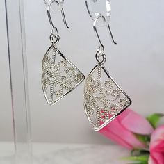 Filigree earrings made by intricate metal work, creating a rich floral and dainty look. The sterling silver long earrings are inspired by Art nouveau jewelry combined with modern design. These square dangle earrings are perfect for a beloved woman, and as a pampering gift for yourself. The vintage style silver earrings are very flattering, comfortable to wear as a jewel for everyday use and impressive as a jewel for a special occasion. The structure of the earrings is approximately 35 mm long, creating an elegant and unique style. The earrings are made of 925 sterling silver by hand tools only. Each piece of jewelry is handmade to order, therefor due to the special nature of handcrafting, there may be slight differences compared to the jewelry in the photos shown. This adds to the charm an Elegant Filigree Earrings For A Gift, Ornate Silver Filigree Earrings, Delicate Handmade Silver Earrings, Nickel-free Art Nouveau Earrings As Gift, Delicate Earrings With Intricate Design For Gift, Sterling Silver Dangle Earrings With Intricate Design, Delicate Earrings With Intricate Design, Delicate Nickel-free Silver Earrings, Ornate Sterling Silver Earrings In Silver