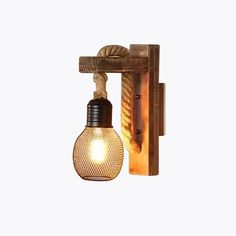 a light that is on the wall next to a wooden frame with rope and bulb