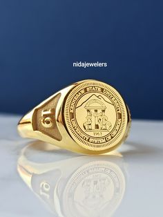 This product is GUARANTEED for life. * College graduation rings for men and women delicately engraved with your school logo or any other initials or image you want. * The ring has solid back. Deep and detailed engraving very delicately handcrafted unisex - looks super cool on both women & men * The ring is 925 Silver * Please contact me for your 14 carat and 18 carat solid gold requests. I can gladly do. * Certified 14k solid gold, hallmarked 14k for solid gold rings. * The ring has solid ba Classic Jewelry For Commemoration With Hallmarks, Silver 14k Gold Ring For Commemoration, Elegant Round Signet Ring For Commemoration, Engraved Cluster Ring For Anniversary, Engraved Round Cluster Ring For Anniversary, Yellow Gold Signet Ring Stamped 925 For Anniversary, Symbolic 925 Stamped Engraved Ring For Formal Occasions, Oval 14k Stamped Commemorative Rings, Oval 14k Stamped Commemoration Ring