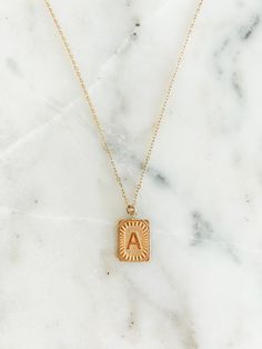 Experience the luxury of our 18k gold-plated stainless steel Initial Necklace! Free of lead and nickel, with a 16-inch chain and a 4-inch extender, you'll be stylishly adorned for any occasion. Gold-plated Locket Necklace With Adjustable Chain, Everyday Adjustable Gold Name Necklace, Gold Metal Initial Pendant Necklace, Gold Metal Pendant Initial Necklace, Classic Gold Charm Necklace With Square Pendant, Initial Pendant Necklace Gift For Her, Tarnish Resistant Initial Pendant Necklace For Her, Tarnish Resistant Initial Pendant Necklace As Gift For Her, Gold Chain Medallion Necklaces For Gifts