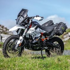 a motorcycle parked on the side of a hill