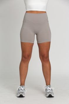 Level up your activewear with our Grey Mist V-Cut Shorts 5". The flattering V-Cut design at the waistband accentuates your curves and provides a secure fit. Buttery soft material with built-in pockets, these shorts are the perfect combo of comfort and functionality. Polyester / Spandex Blend V-Cut Waistband Built-In Side Pockets Model Details: Modeled in size: Medium Model Bust: 34 Model Waist: 30 Model Height: 5'6 Workout Activewear With 5-inch Inseam And Side Pockets, Fitted Bottoms With Built-in Shorts For Light Exercise, Compression Activewear Shorts With Pockets, Stretch Activewear With Pockets And Short Inseam, Activewear With Pockets And Short Inseam For Workout, Yoga Activewear With Pockets Mid-thigh Length, Compression Activewear With Pockets And Short Leg, Workout Shorts With Contoured Waistband And 5-inch Inseam, Compressive Yoga Shorts With Pockets