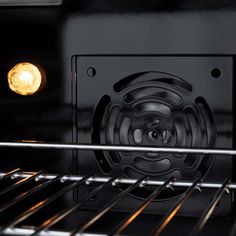 an oven door is open with the light on and it's grill in view