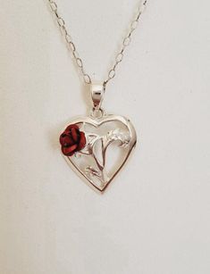 This beautiful pendant necklace features a heart-shaped rose flower design, crafted from high-quality sterling silver. The amulet-style pendant hangs from a 19-inch rope chain with a hook closure. Perfect for anniversaries or special occasions, this vintage piece is sure to add a touch of love to any outfit. The silver metal and 925 parts per 1000 purity make it a long-lasting and valuable addition to any jewelry collection. Rose Sterling Silver Jewelry For Valentine's Day, Valentine's Day Flower Pendant Jewelry With Rose Design, Valentine's Day Rose Design Flower Pendant Jewelry, Sterling Silver Necklace With Rose Flower Pendant, Rose Heart Necklace For Valentine's Day, Valentine's Day Rose Heart Necklace, Heart Pendant Necklace With Rose Design For Anniversary, Sterling Silver Rose Design Jewelry For Gift, Valentine's Day Sterling Silver Rose Jewelry