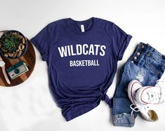 Show your school spirit with our Wildcats shirts, perfect for every sport and club! 🐾 Whether you're cheering from the sidelines, hitting the field, or representing your favorite club, these shirts are made for you! Customize with your sport or club name to make it uniquely yours. Go Wildcats! 🎉 Bella and Canvas Unisex TShirt #WildcatsPride #TeamSpirit #ClubLife #WildcatsNation #GoWildcats #SchoolSpirit #GameDayReady #SupportYourTeam #BootsandRootsApparel #Mompreneur #CustomWildcatsShirts #Pro Varsity T-shirt For College Football Season, College Football Season T-shirt With Screen Print, College Football Season Screen Print T-shirt, Team Spirit T-shirt With Team Name For College, University Logo T-shirt For Sports Events, Varsity T-shirt With Team Name For College, College Sports Fan T-shirt With Screen Print, Sports Fan T-shirt With Screen Print For College, University Logo Sports Tops For Sports Season