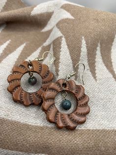 Leather Concho earrings. Made in Wyoming. Quality leather and stone used. Hypoallergenic earring wires. Hand Tooled Adjustable Jewelry For Everyday, Bohemian Leather Drop Earrings, Unique Brown Round Earrings, Hand Tooled Bohemian Jewelry For Everyday, Leather Dangle Earrings With Ear Wire, Bohemian Hand Tooled Jewelry For Everyday Use, Bohemian Leather Dangle Earrings, Bohemian Brown Pierced Hoop Earrings, Earthy Brown Earrings With Ear Wire