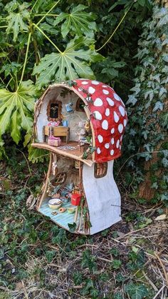 a mushroom like house in the middle of some plants