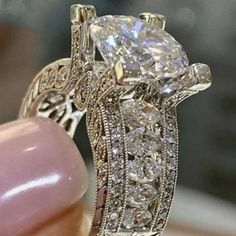 a close up view of a diamond ring on someone's finger