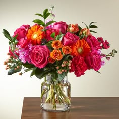 a vase filled with lots of different colored flowers