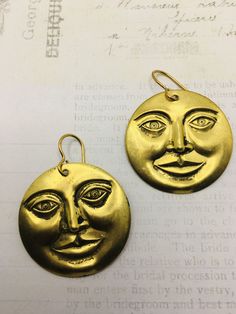 "Brass man in the moon face dangle earrings. 1 1/4\" round. They dangle 1 1/2\" long. These are vintage 1970's brass charms. They have never been used until now. Vintage quality and made to last a lifetime. Last photo shows a popular locket in my shop made with this same brass stamping. I offer quick shipping and all packages arrive ready for gift giving. free domestic shipping! I also offer low international shipping rates because I love my international customers! Here is the link to my shop: Vintage Moon-shaped Earrings For Gift, Vintage Moon Shaped Earrings For Gift, Vintage Moon Earrings For Gift, Vintage Moon-shaped Metal Earrings, Vintage Moon Shaped Earrings, Vintage Moon Earrings, Moon Face Earrings, Handwritten Gifts, Man In The Moon