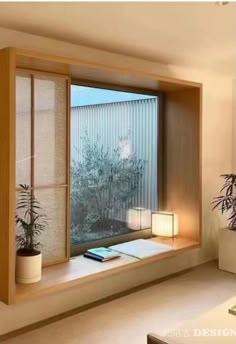 a living room filled with furniture and a large window covered in blinds next to a potted plant