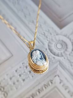 "Featuring a blue agate cameo necklace framed with a golden silver sterling 925 textured frame and chain. ✨ design: Charming white young lady surrounded by long loose hair on a blue background. Shape: Oval. Very charming and elegant, the perfect gift any woman would like to receive. Silver sterling 925 *available also with a silver frame. View \"Cameo Necklaces\" section in shop! ➳Agate is a variety of banded Chalcedony, which is a variety of the mineral Quartz, known for helping you express you Victorian Cameo Locket Necklace As A Gift, Ornate Intaglio Necklace As Gift, Cameo Medallion Jewelry For Gifts, Cameo Medallion Jewelry Gift, Cameo Round Pendant Necklace For Wedding, Elegant Oval Cameo Locket Necklace, Blue Cameo Necklace For Wedding, Blue Cameo Jewelry For Wedding, Blue Cameo Jewelry Gift