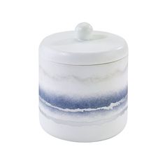 a white and blue jar with a lid